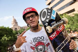 Skate boarder showing off his Oakely eyeglasses